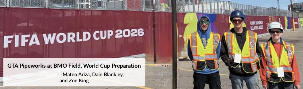 Three GTA Pipeworks crew members in hard hats and hi-vis vests beside FIFA World Cup 2026 hoarding at BMO Field, Toronto