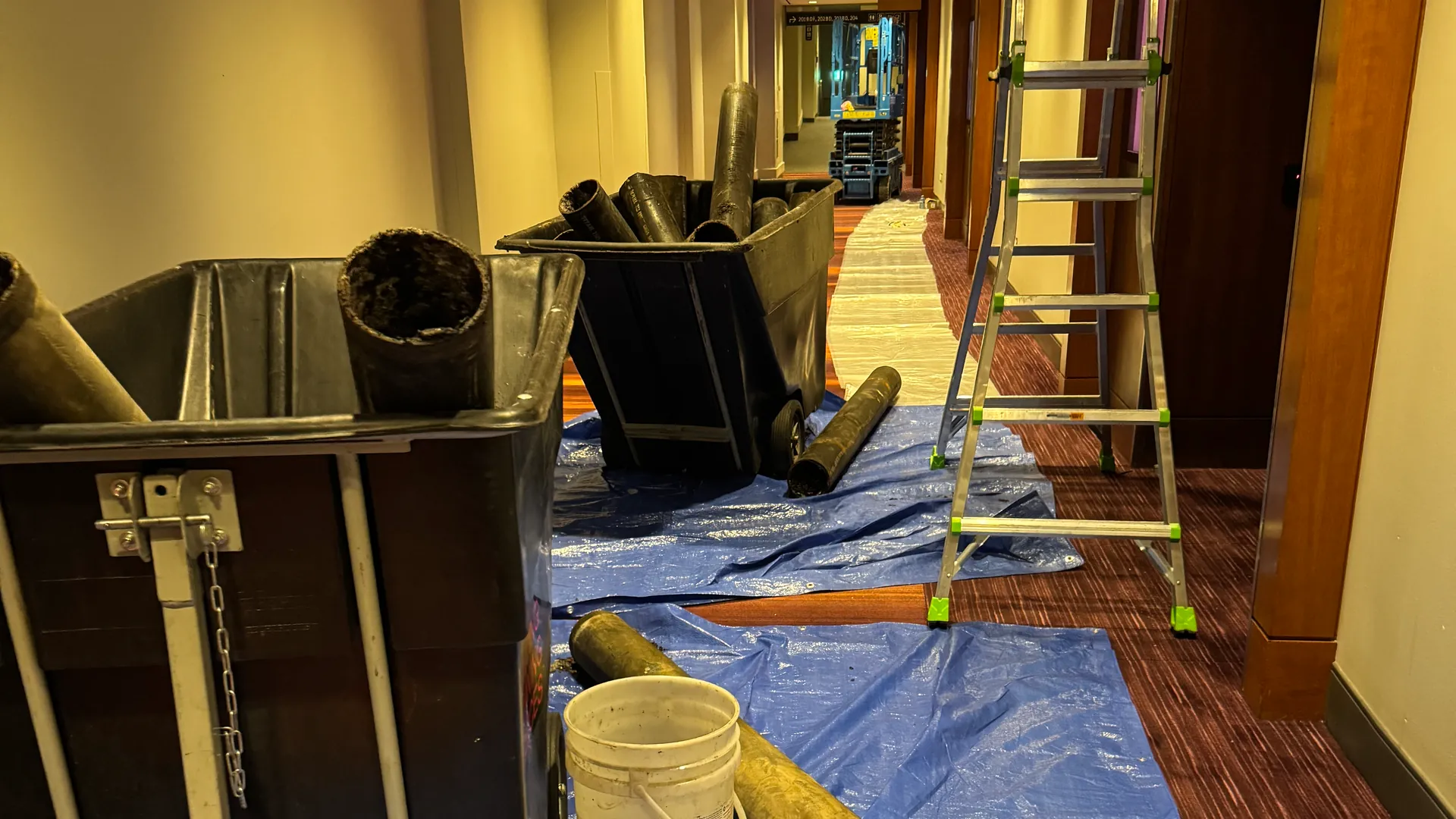 Removed cast iron pipe in carts on protective tarps in a Metro Toronto Convention Centre corridor